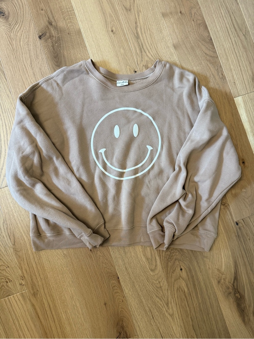 Women’s smiley face crewneck in light brown